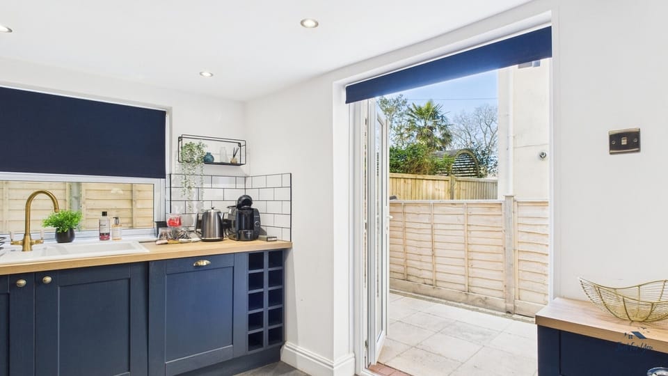 The kitchen features double doors that lead directly out to the private enclosed courtyard garden.