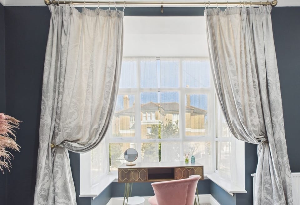 A dedicated dressing area in the master bedroom with a mirror and ample light for getting ready.
