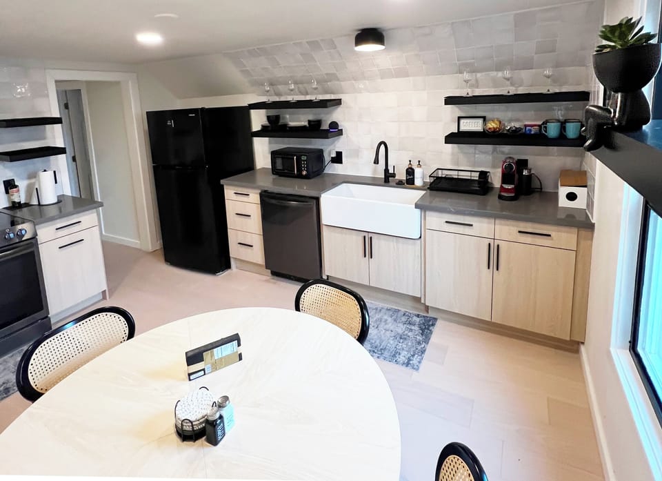 A fully stocked kitchen with sleek appliances and plenty of counter space for cooking.