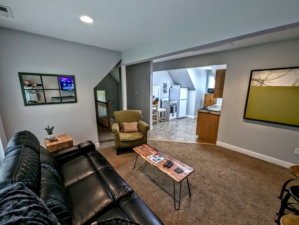 Upper level living room with ample seating and flat-screen Roku TV.