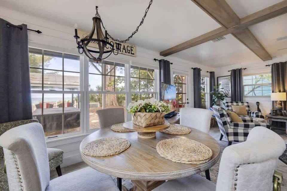 Charming dining nook with a four-seat table, complemented by four stools at the kitchen counter, offering plenty of seating for you and your guests.