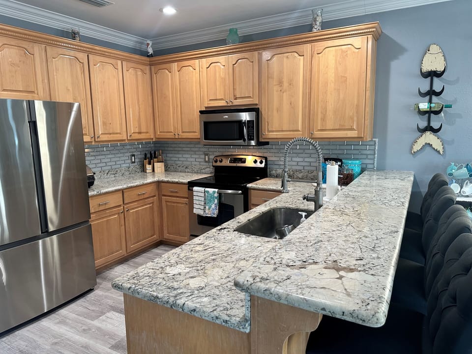 Kitchen is stocked with all dishes, utensils, pots and pans and small appliances