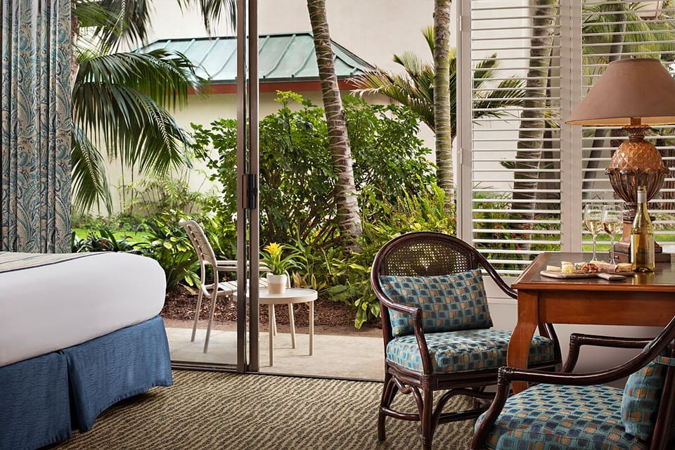 Sip morning coffee beside tropical greenery just outside.