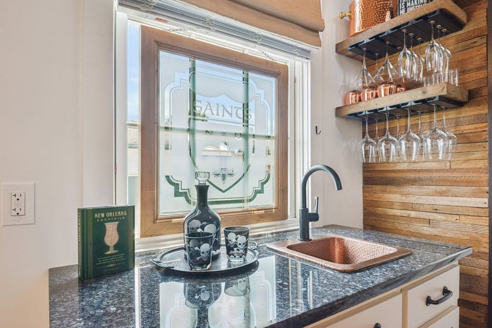 Wet bar with glassware and barware.