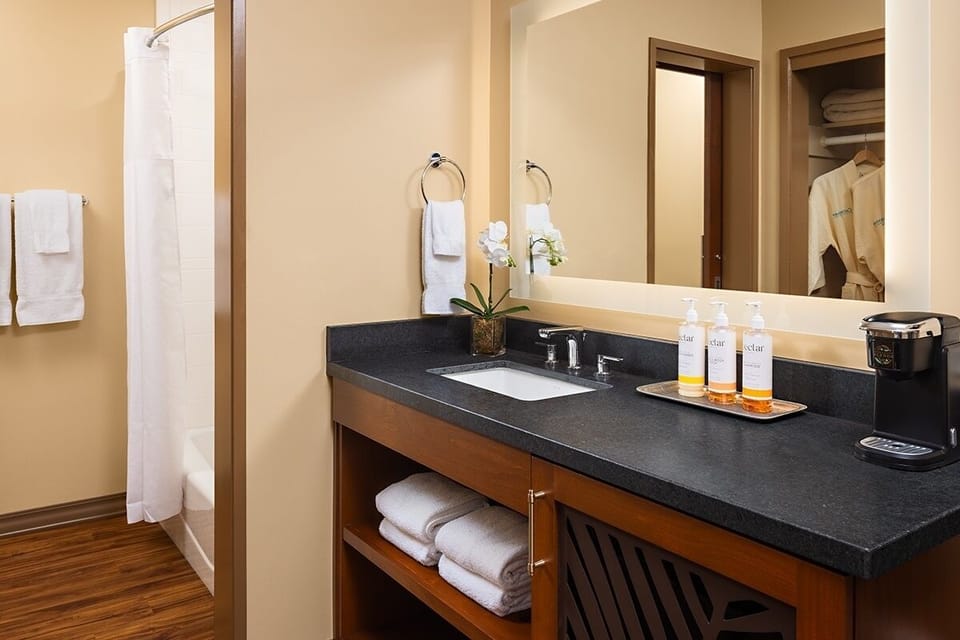 Refresh with spacious vanity space and easy in-room convenience.