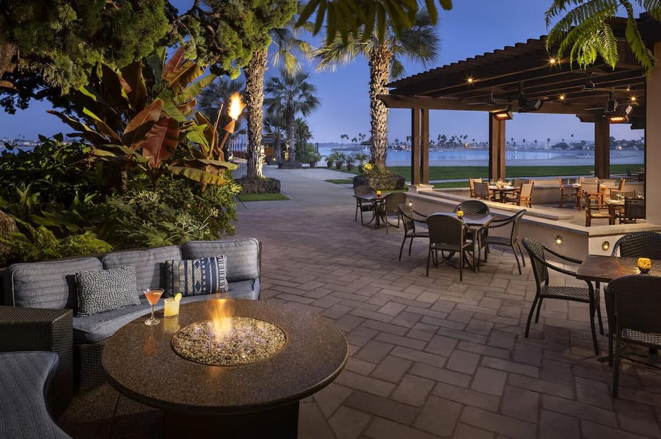 Gather by the glowing fire pit for breezy sunset cocktails.