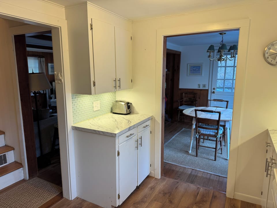 Kitchen looking into dining room and side door leading to driveway/garage.