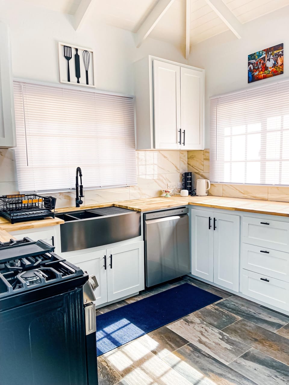 Modern kitchen with farmhouse sink and built-in dishwasher. 