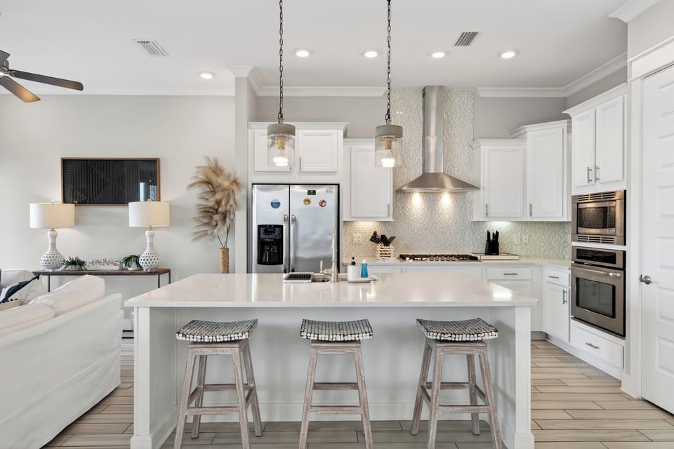A bright, chef-ready kitchen made for group trips—spacious island seating, modern appliances, and an easy flow into the living space for effortless hosting.
