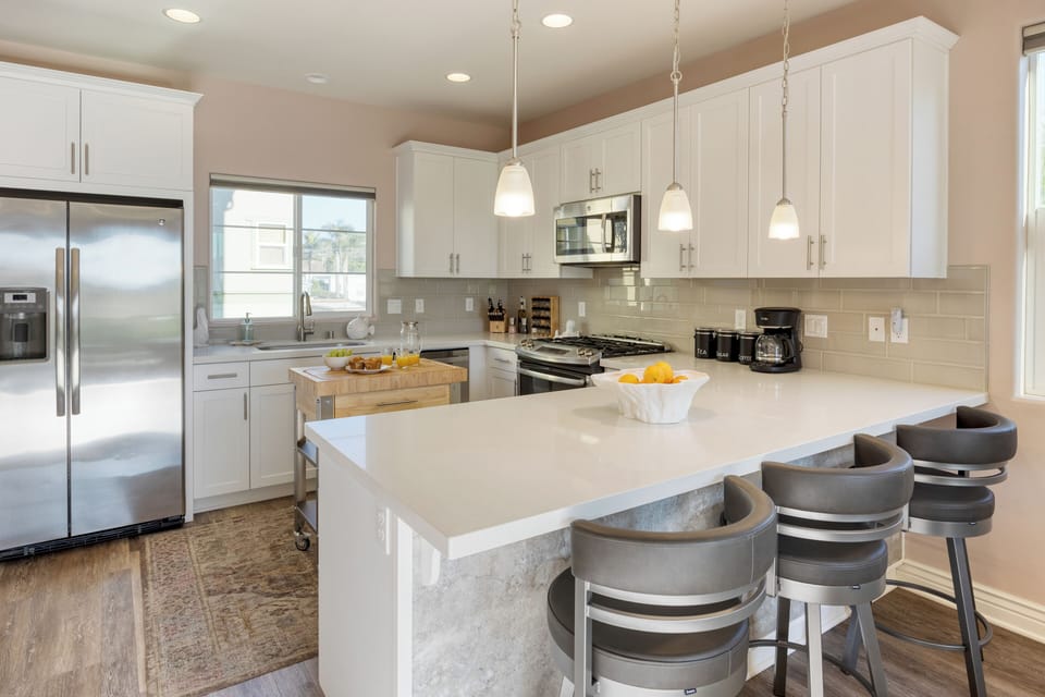 Additional barstool seating at the kitchen counter.