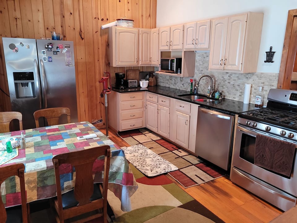KITCHEN:  The home has a very large kitchen with all appliances including a dishwasher as well as a dining area that seats 4 adults.
