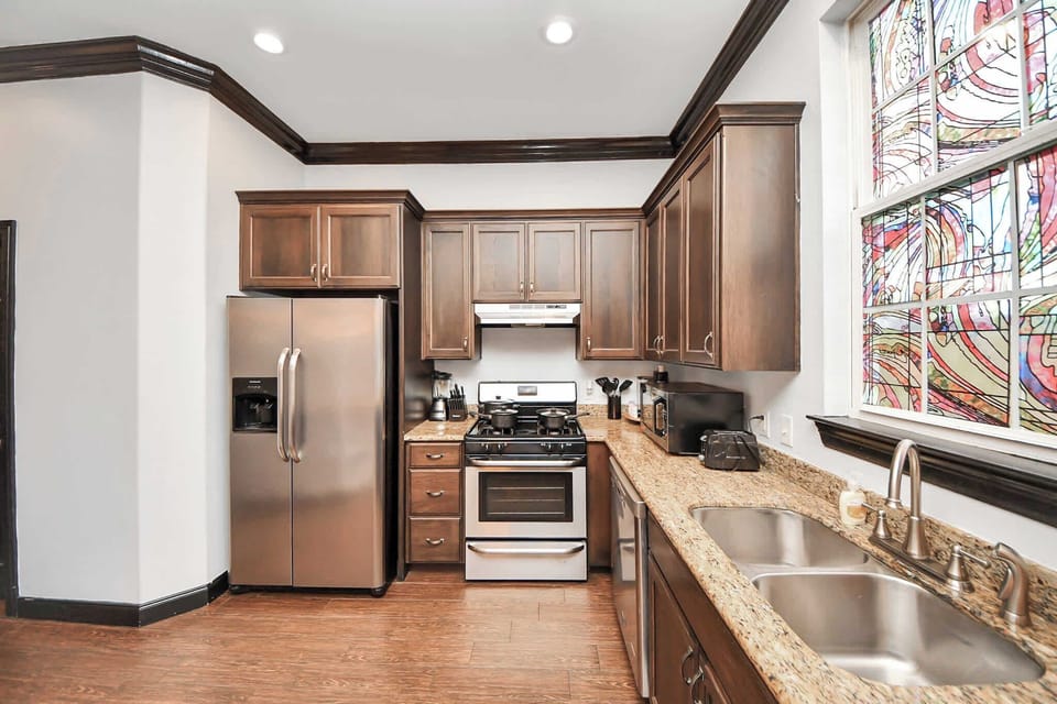 Comfort Meets Functionality: Enjoy this sleek, fully equipped kitchen with stainless steel appliances and plenty of counter space.