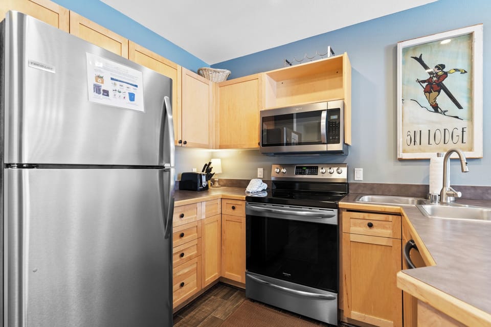 Full kitchen with stainless steel appliances.