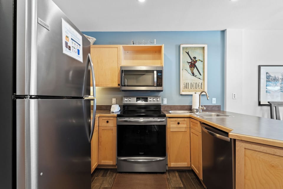 Full kitchen with stainless steel appliances.