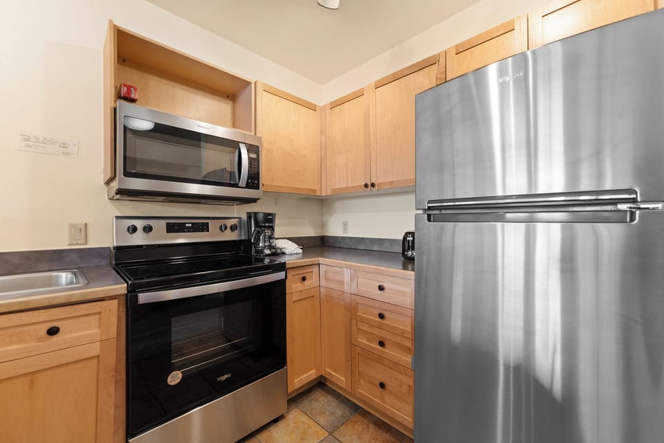 Full kitchen with stainless steel appliances.