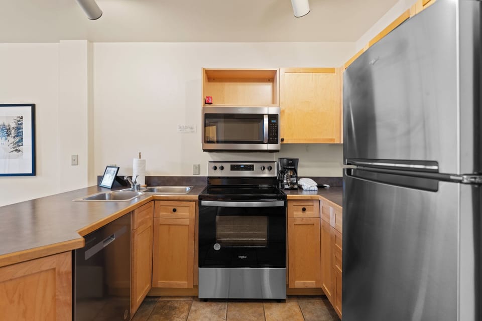 Full kitchen with stainless steel appliances.