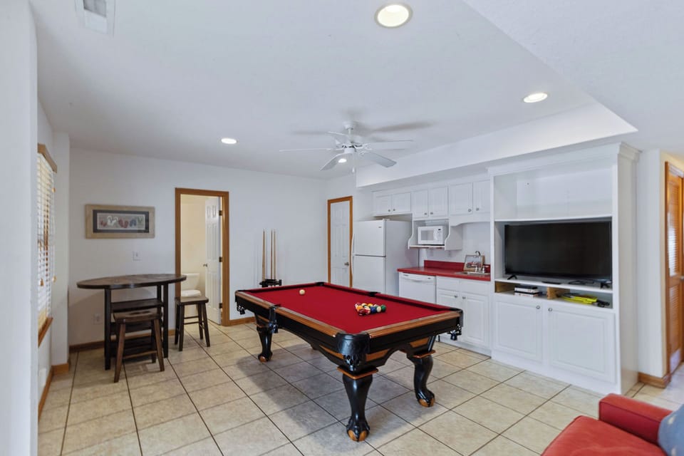 Game Room - Pool table, pub table, wet bar and a cozy couch make for a fun time in the recreation room.