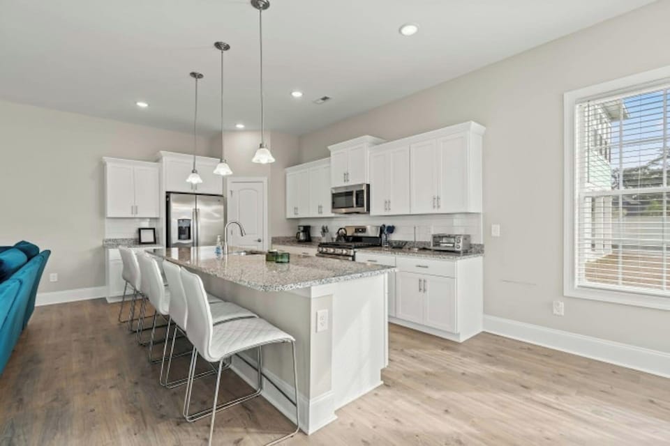 The kitchen island provides additional counter space for serving snacks or meals