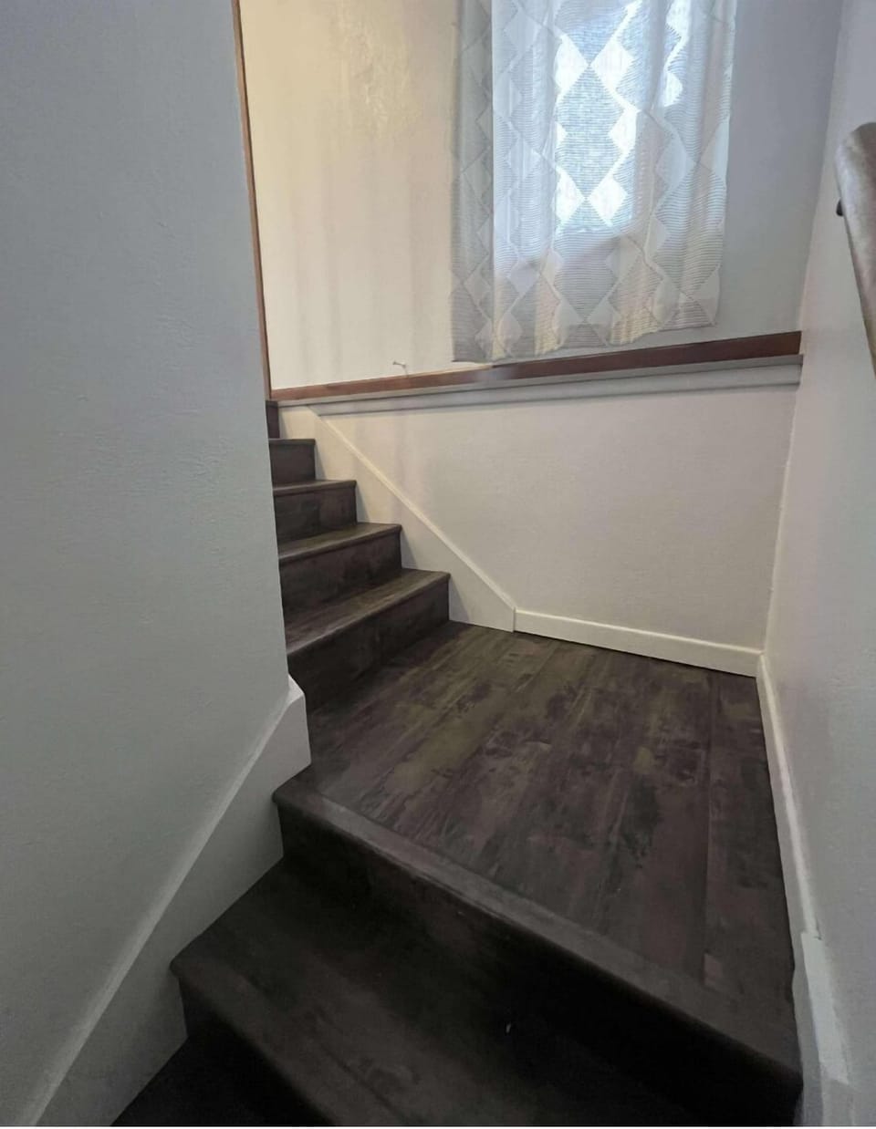 Stairs landing and remaining stairs to go up to the main floor.