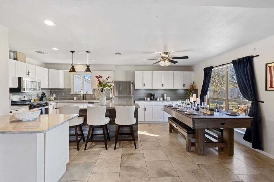 Fully equipped kitchen plus a dining table that converts to ping pong and pool.