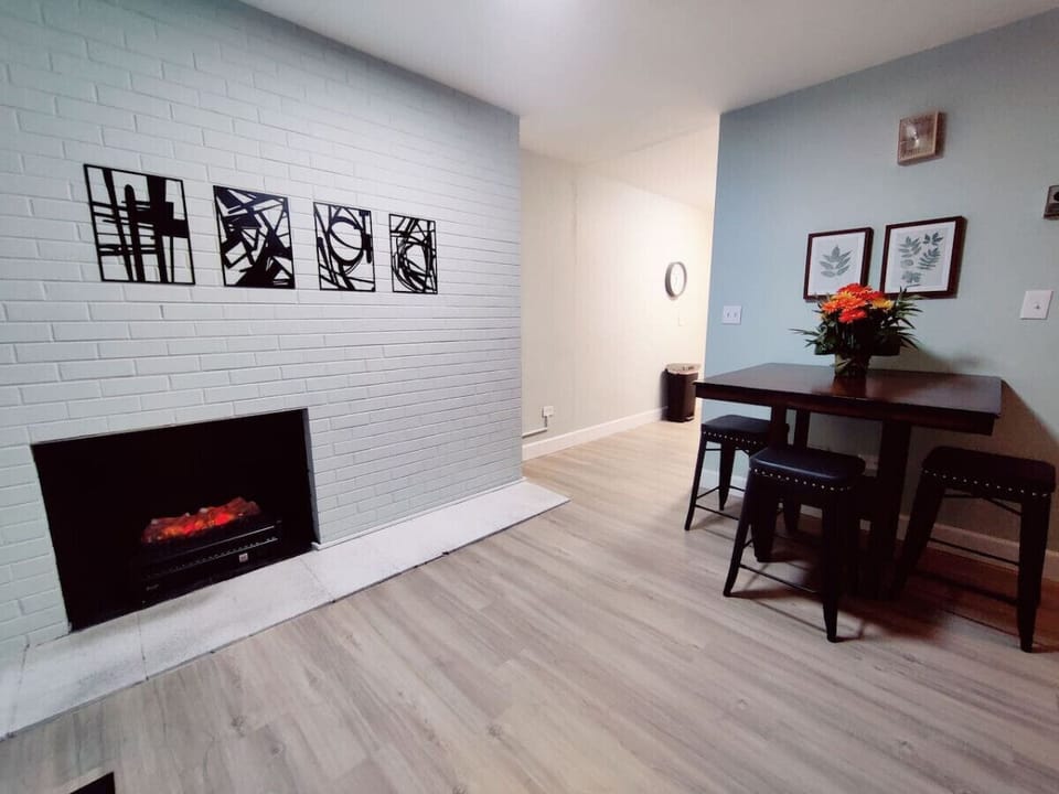 With a gorgeous table, elegant chairs, and a soothing fireplace, what an ideal spot to unwind after a long day.