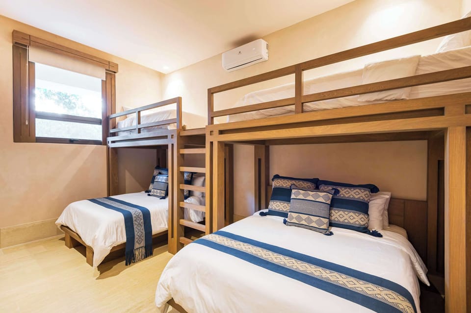 Bedroom 3 with two bunk beds, lower bunks are queen size, the top bunks are singles