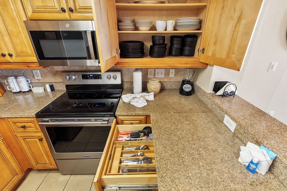 Fully-stocked kitchen with all necessary utensils, blender, and more.