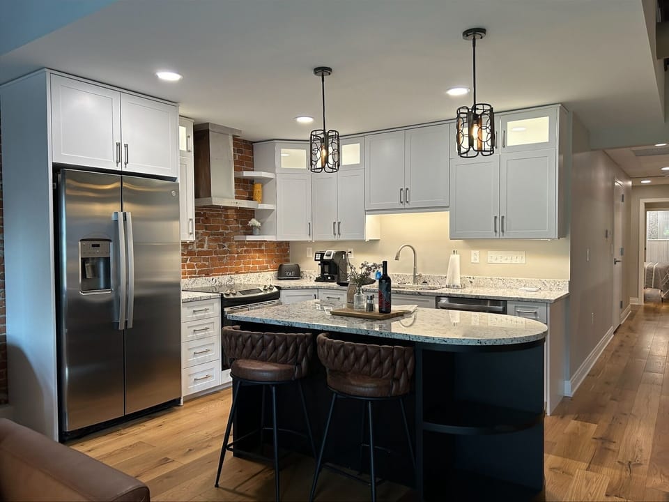 Custom kitchen w/ granite. Stocked with everything to cook meals and snacks.