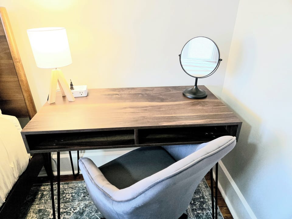 Desk with vanity mirror, light, and extra USB/Power outlets.