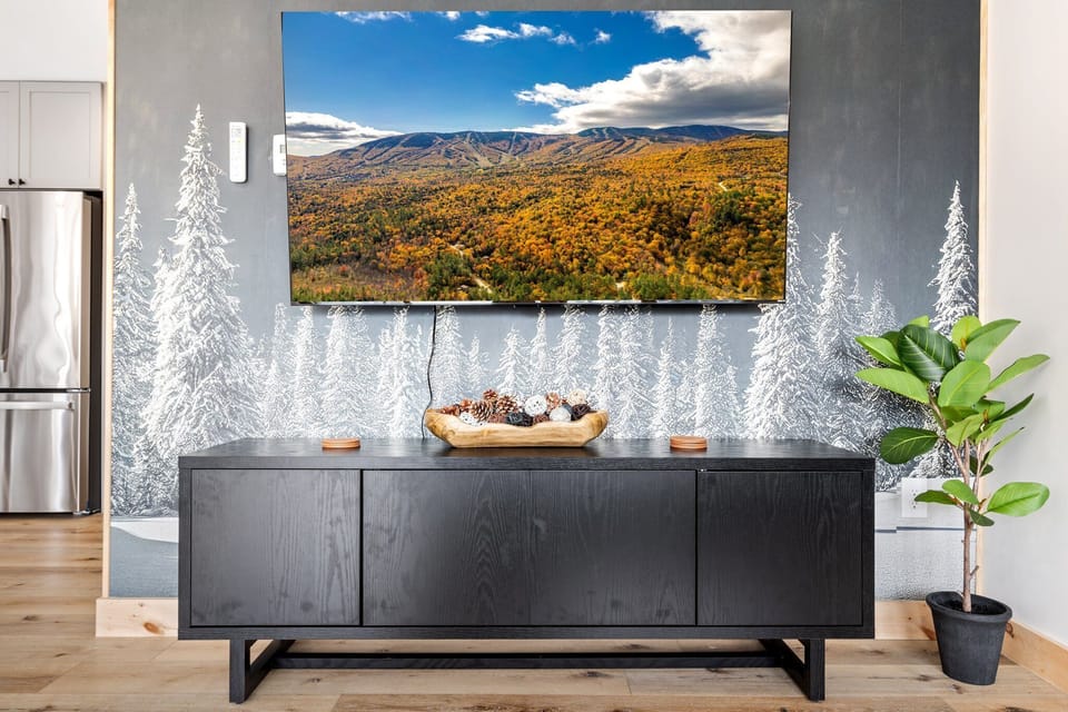 Our living area combines comfort and entertainment, with a soft sofa and a big-screen TV to enjoy.