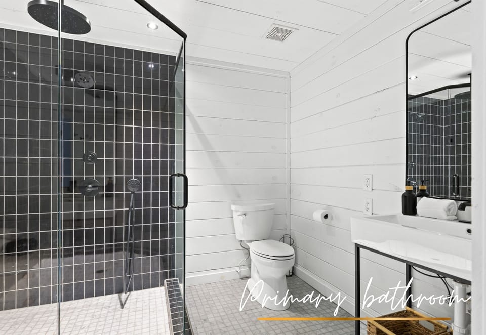 Freshen up in this sleek and modern bathroom, featuring luxurious finishes and plenty of space.