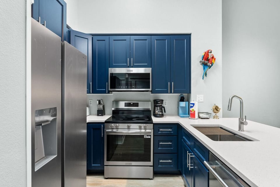 Fully equipped kitchen featuring stainless steel appliances, ample counter space, and everything needed for home-cooked meals.