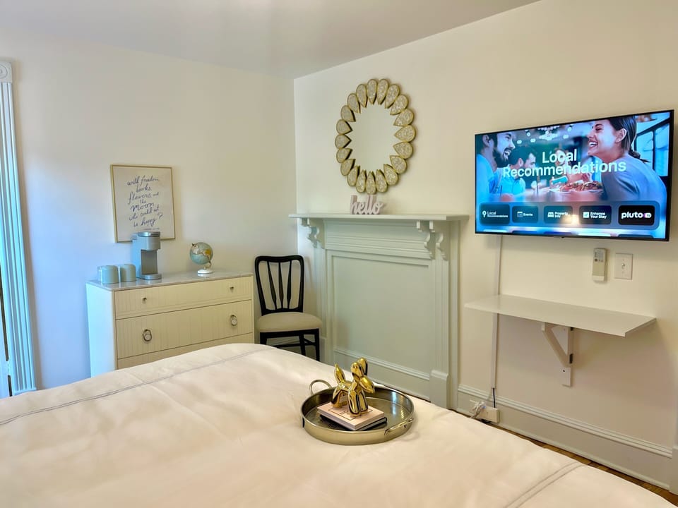 Room 5: Mint green accents, King Anthropologie Velvet Bed, 45" Smart TV, marble bath with glass enclosed shower