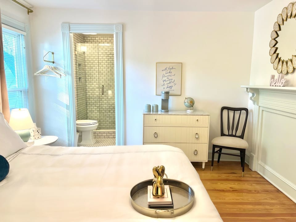 Room 5: Mint green accents, King Anthropologie Velvet Bed, 45" Smart TV, marble bath with glass enclosed shower