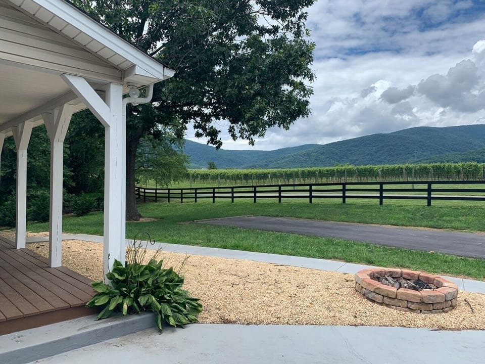 The large front porch is complete with rocking chairs and plenty of adirondack chairs are stored for enjoying the fire pit!