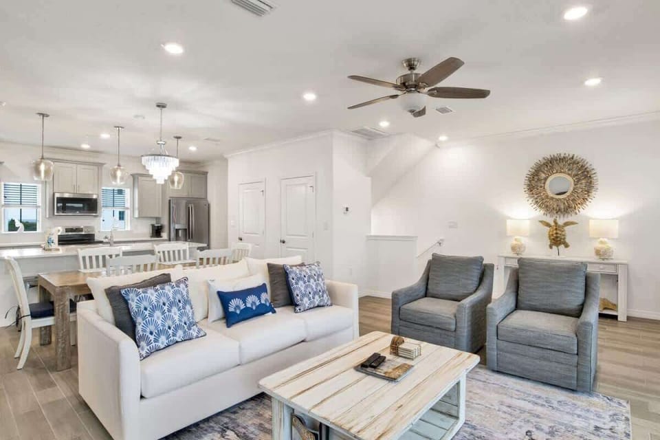Spacious living room featuring ample seating, a smart TV, and access to a screened-in patio for relaxed gatherings.