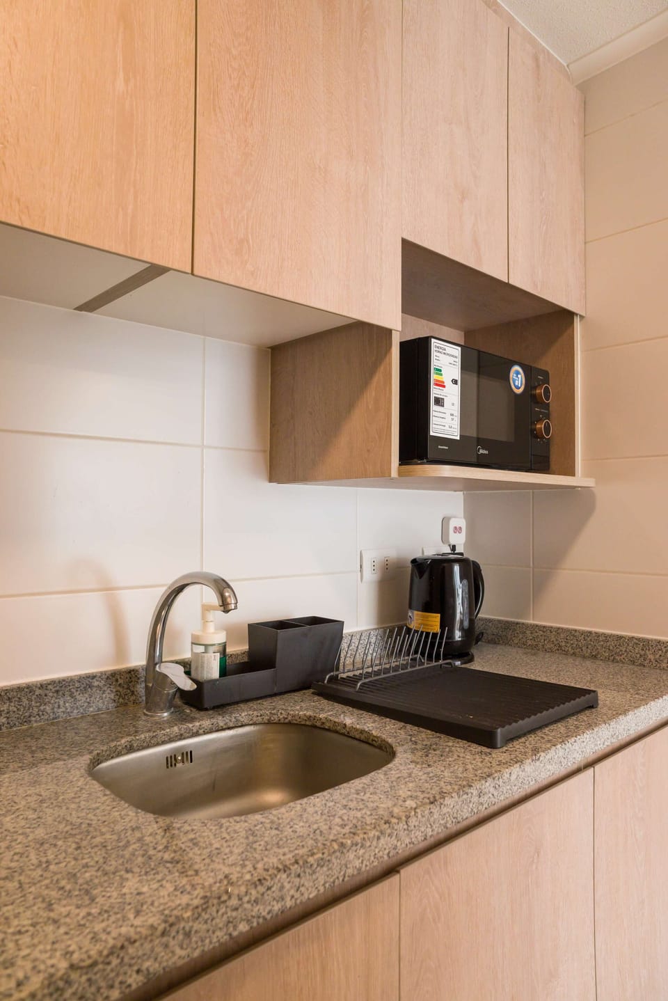Modern kitchenette with essential amenities for a convenient stay.