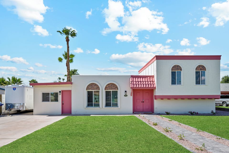 The pink door to the far left of the home is the private access for this studio apartment.