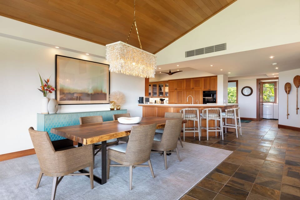 Stunning dining area with a table seating six, opening to breathtaking outdoor views.