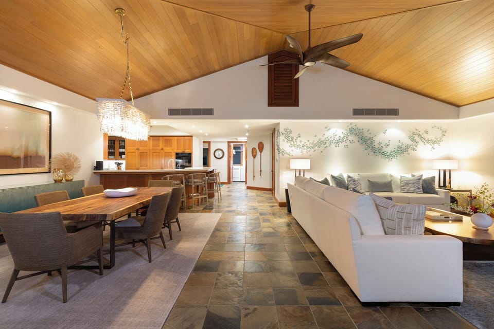 Relax in this stunning open-concept space where warm wood meets modern elegance, perfect for gathering with loved ones under soaring ceilings.