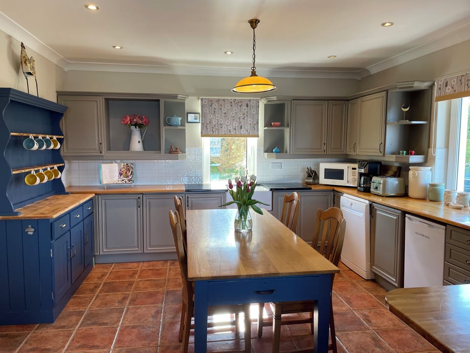 Open plan kitchen with electric cooker, dishwasher, fridge, microwave etc..