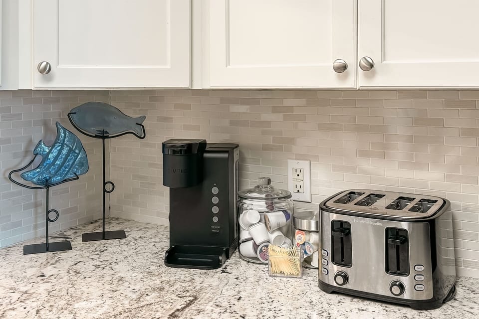 Coffee bar with cream and sweetener options. Coffee pods are provided for single cup servings.