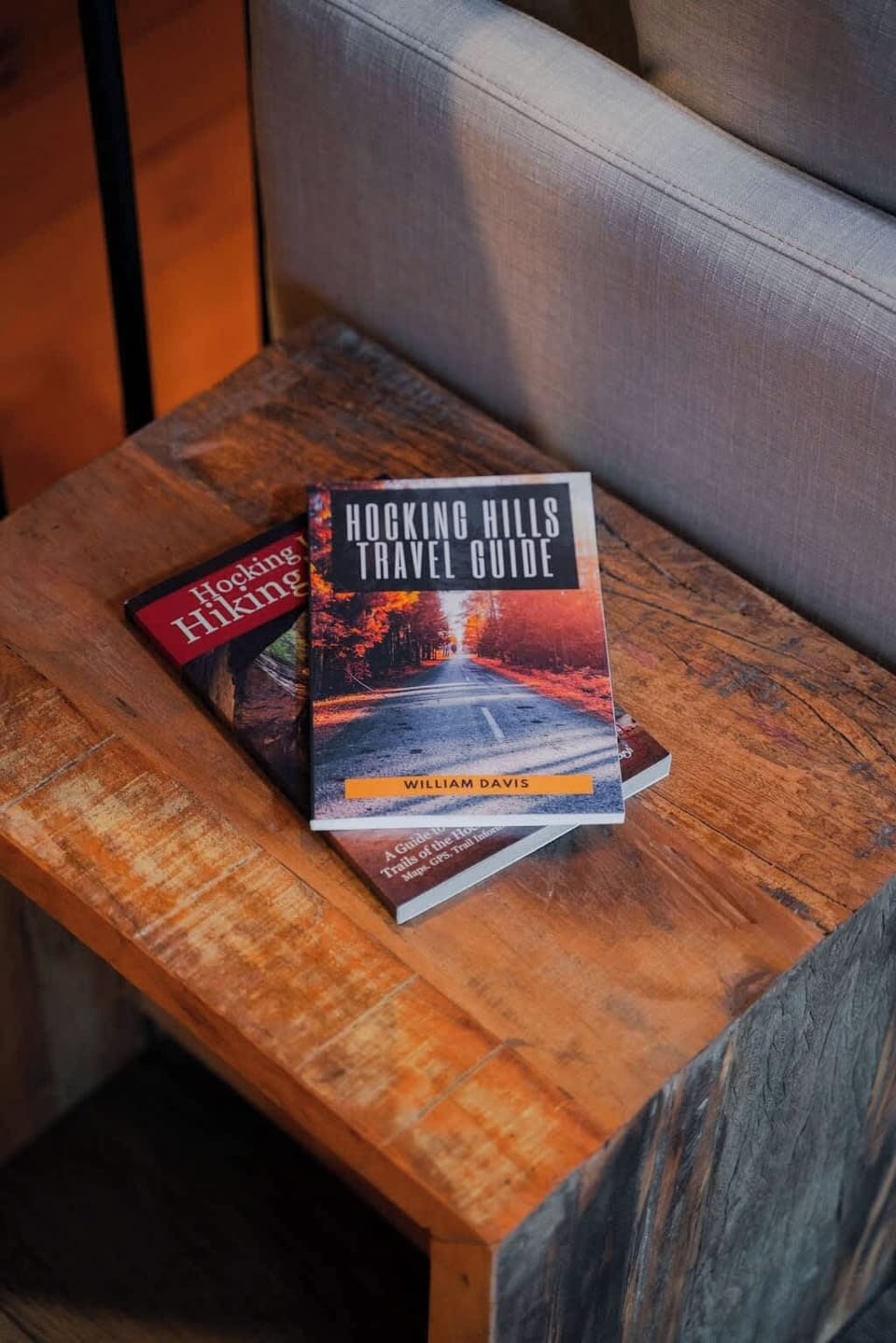 Adventure Awaits: Discover hiking treasures with our travel guides on the rustic side table!