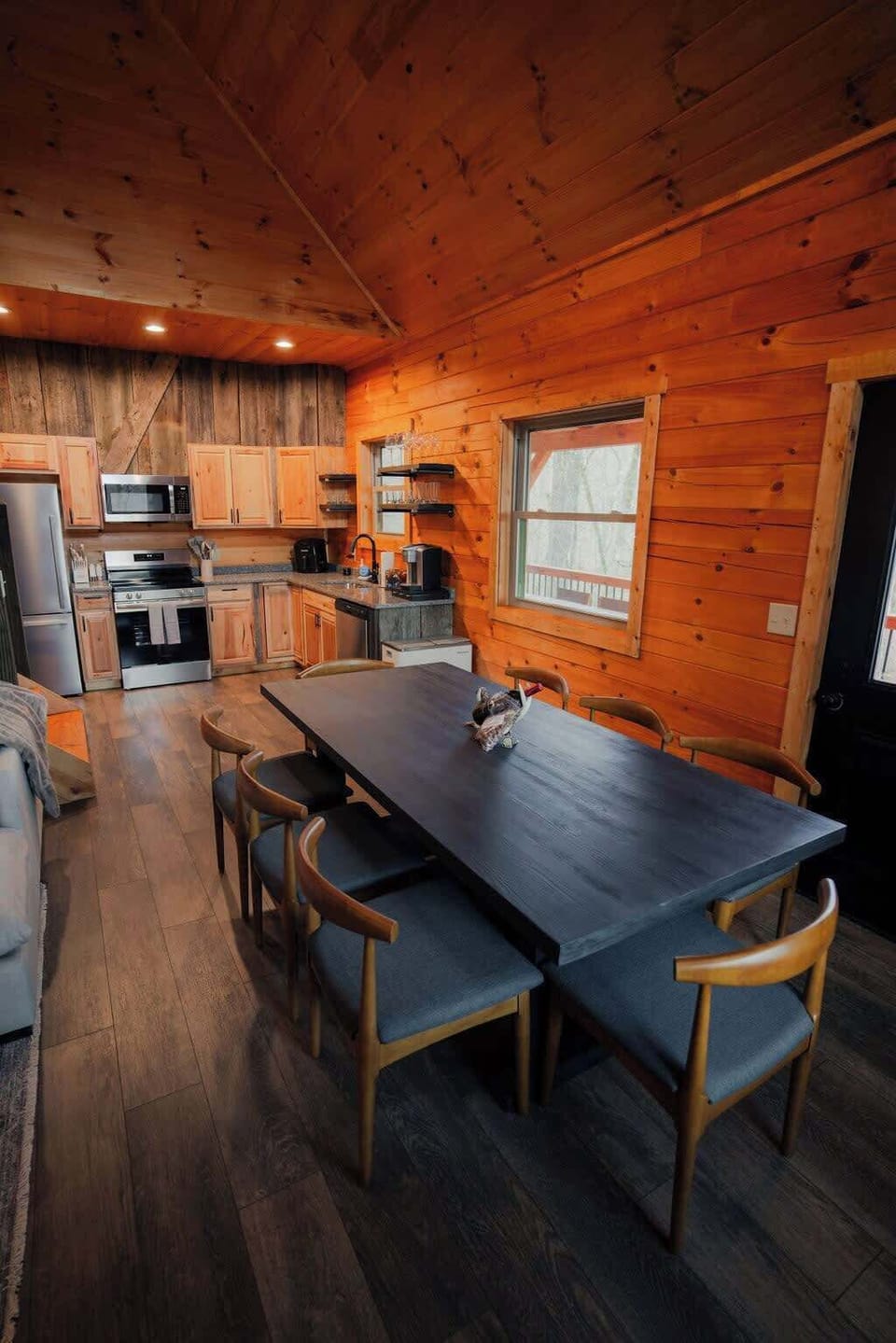 Dining Room: Gather around the chic table and savor meals with breathtaking woodsy views!