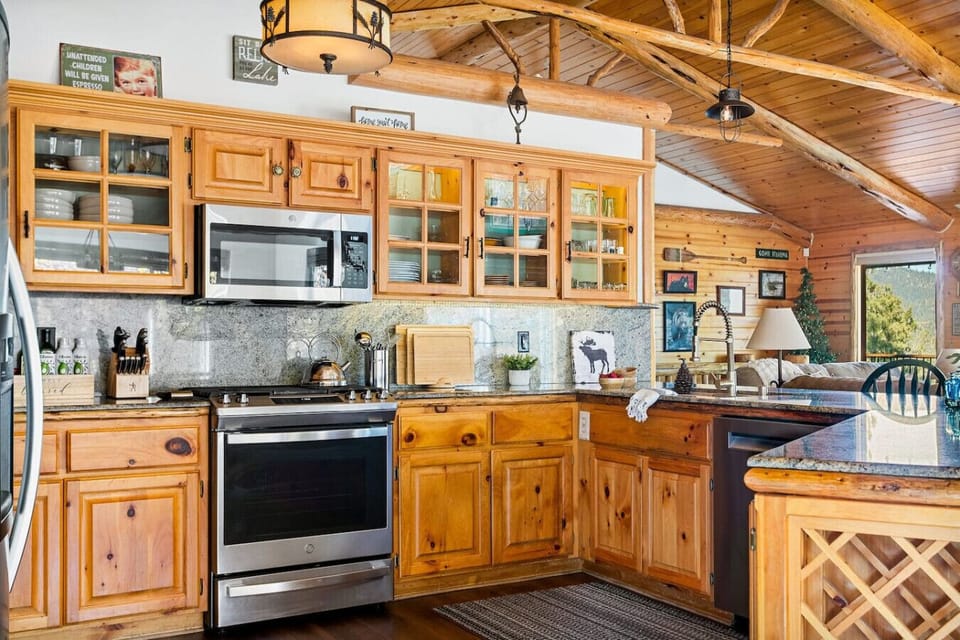The sleek granite countertops, stylish backsplash, and warm pine cabinets create an inviting space to prepare culinary delights.