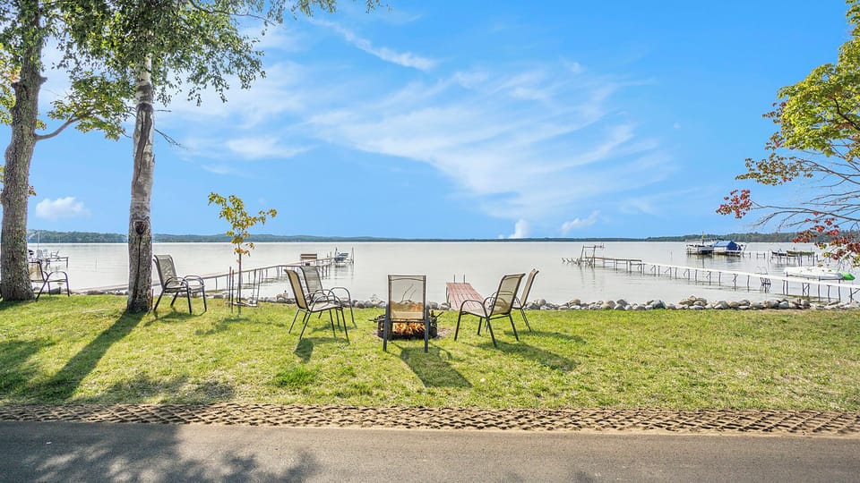 The firepit is in front of the beach and dock