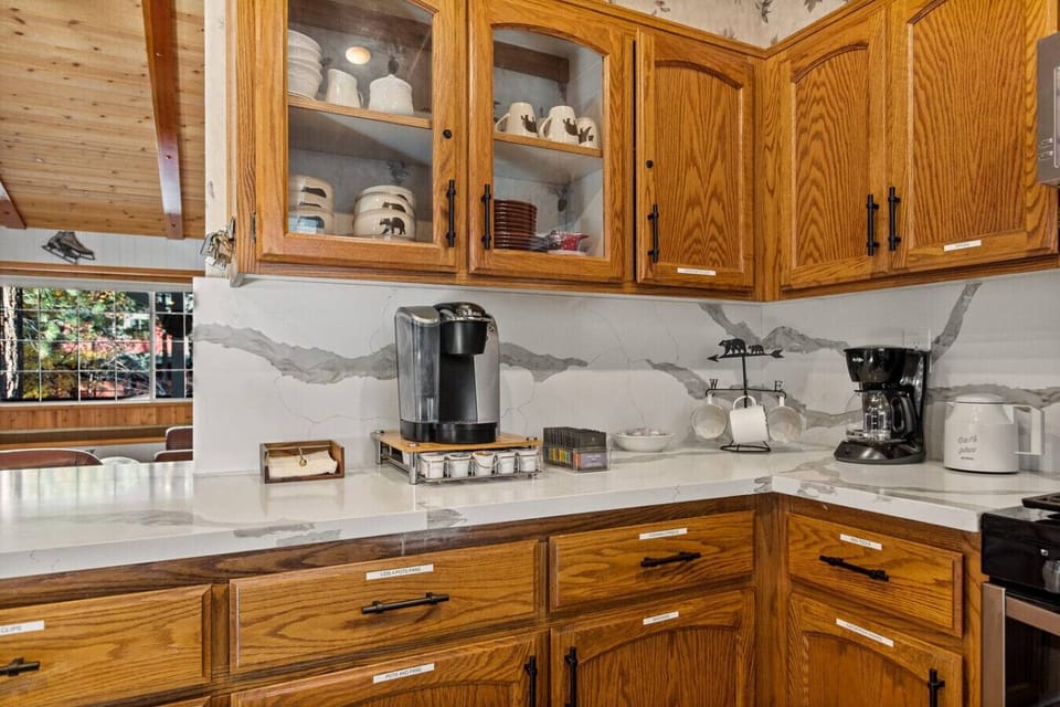 The gourmet kitchen, equipped with both a drip coffee maker and a Keurig, is perfect for morning brews.