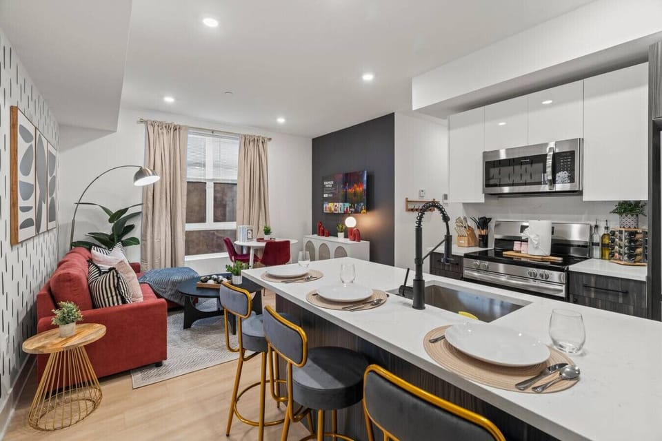 Open-concept living area with a stylish kitchen, vibrant decor, and cozy spaces for relaxing and dining.