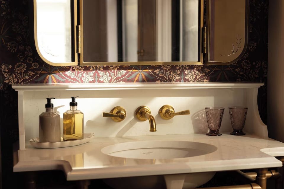 Start your day at a marble vanity with brass accents.