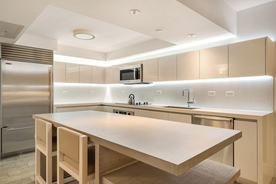 The kitchen features sleek, stainless steel appliances